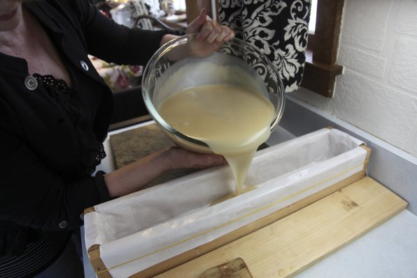 Mary D'eAngelis pours some soap into a mold.