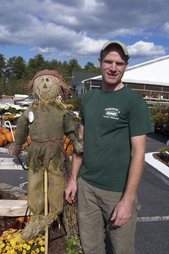 Osborne Agway owner Tom Osborne (right) and a scarecrow.