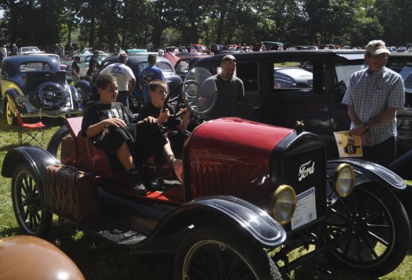 Mason and Chase Langevin are ready to take a 1917 Ford Speedster for a spin as Matt Fish looks on.