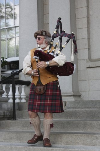 David Stewart-Smith performs a number on the bagpipes from the steps of the State House.
