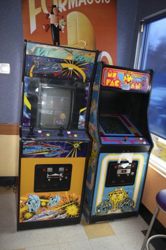 <strong>Vapor Trail & Ms. Pac-Man</strong></p><p>The Yellow Submarine on Loudon Road has two arcade cabinets. One of them, Ms. Pac-Man, should be very familiar. This machine showcases the gamer’s feminine side and is a clear departure from the original Pac-Man. I mean, now that little circle has a bow on it! Sadly, in the male-dominated world of gaming, Ms. Pac-Man is still one of only a few female protagonists. We had some fun with Vapor Trail as well, a birds-eye-view flying game which basically involves frantically bashing the shoot button while manipulating the joystick.