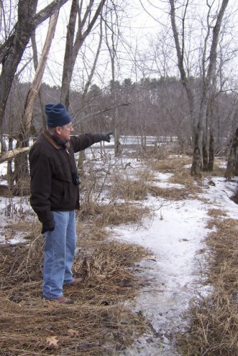 Dick Lemieux points to the marshy area soon to be spanned by a boardwalk as part of the Merrimack River Greenway Trails. Lemieux is spearheading efforts to build the bicycle trail, which would run from Pembroke to Boscawen.