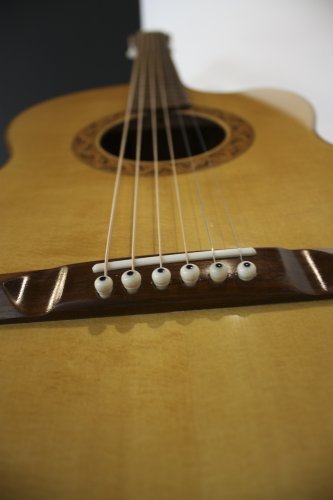 Alan Carruth also crafted this 12-fret “fingerstyle” guitar, made from North American woods. “Since music can only exist in the act of creation,” Carruth said,  “and is not directly representational, it has a claim to being the most abstract of all arts.”