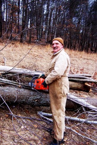 Hermel Fortier gets busy sawing up wood to heat his home. It may be nice out today, but winter is coming.