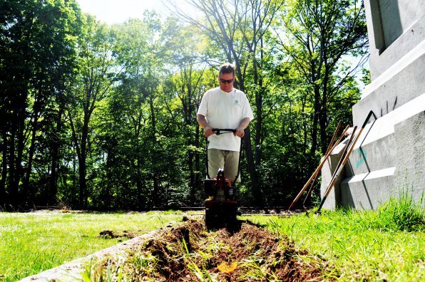 Richard Snaith does some landscaping work at the Hannah Dustin monument.