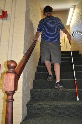 Tim gets a feel for walking down stairs without the benefit of sight. Thanks to some training from the New Hampshire Association For The Blind, he made it safely – and he didn’t even peek.