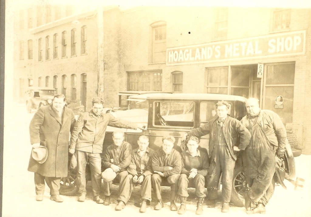 This phote was taken in mid 1920's to 1930's I am curious if people can identify the men. I know the 4th in from the right in Addison Rogers. It is the crew at Hoagland's Metal Shop in Concord