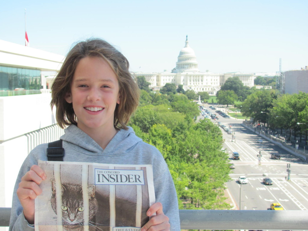 Brenna McNamara on the balcony of the Newseum in Washington DC.  The state capitol in the background.