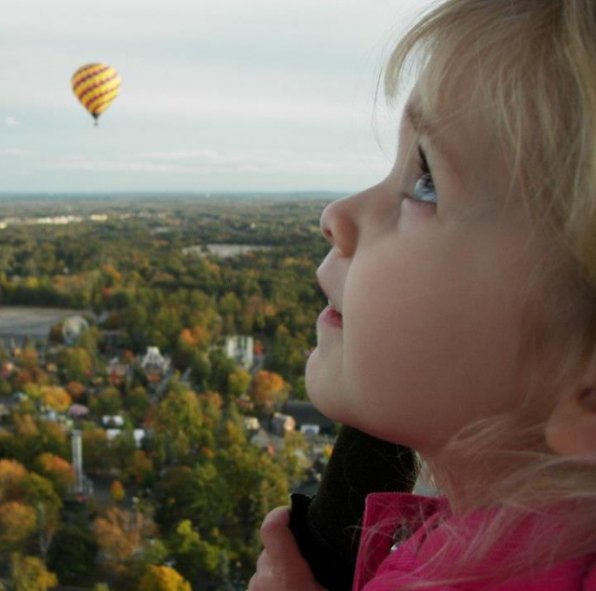 Four-year-old Caia soaks in the view during a family hot air balloon ride.