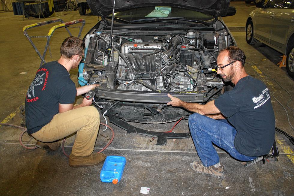 Nate Cushman (left), a senior at the Concord Regional Technical Center, works on the front end of a car at Banks Collision Center with Banks auto technician Rich Tether. (JON BODELL / Insider staff) - 
