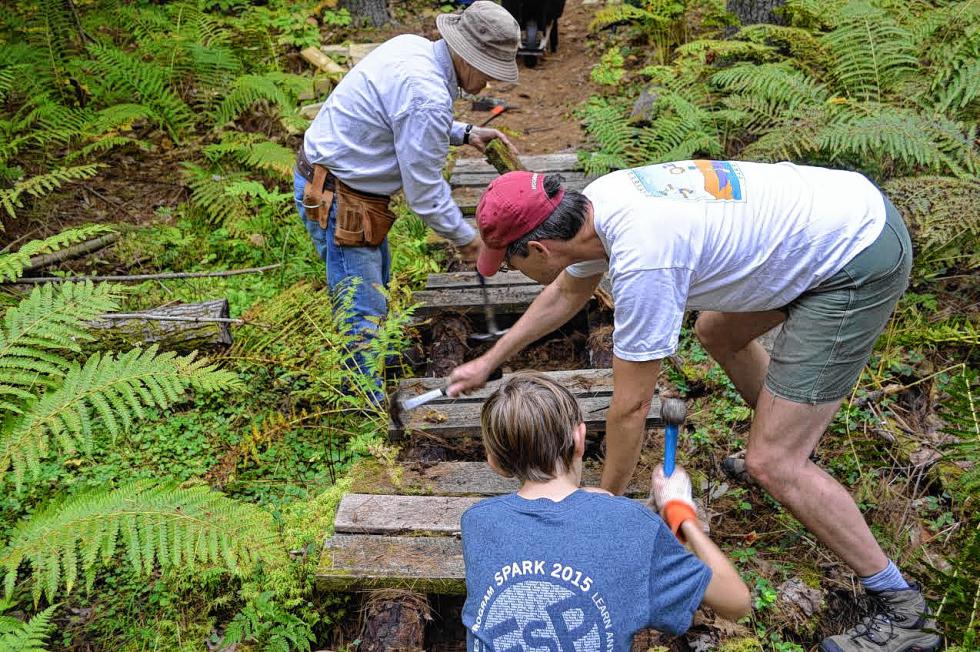 That’s James Jensen, Jim Jensen and Ken Demain rebuilding a bridge on the Boundary Trail in the Bow School Forest. Looks fun, right? Go to the trail care day Saturday and you can do it, too. (MAGGIE JENSEN / For the Insider) - 
