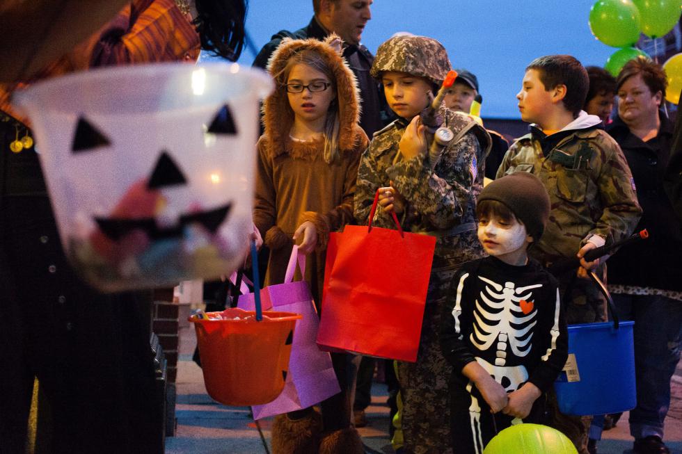Will Garneau, 3, of Concord (bottom center) trick-or-treats in his funny bones skeleton costume during the annual Downtown Halloween Howl on Main Street in Concord on Friday, Oct. 24, 2014. (ELIZABETH FRANTZ / Monitor staff) - ELIZABETH FRANTZ | Concord Monitor