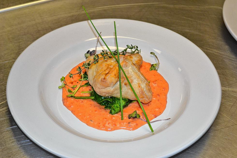 Puff pastry chicken stuffed with Boursin cheese and spinach with a roasted red pepper coulis. What a mouthful – and a tasty one at that. (TIM GOODWIN / Insider staff) - 
