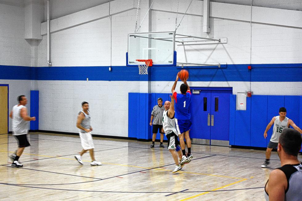 Scott Rollins of the Up2U Fitness team releases a jumper from right around the three-point line at the Boys & Girls Club. (JON BODELL / Insider staff) - 
