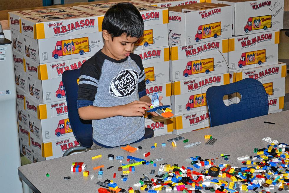 Suyog Nepal is thinking long and hard about what he wants to add to his Lego creation. (TIM GOODWIN / Insider staff) -