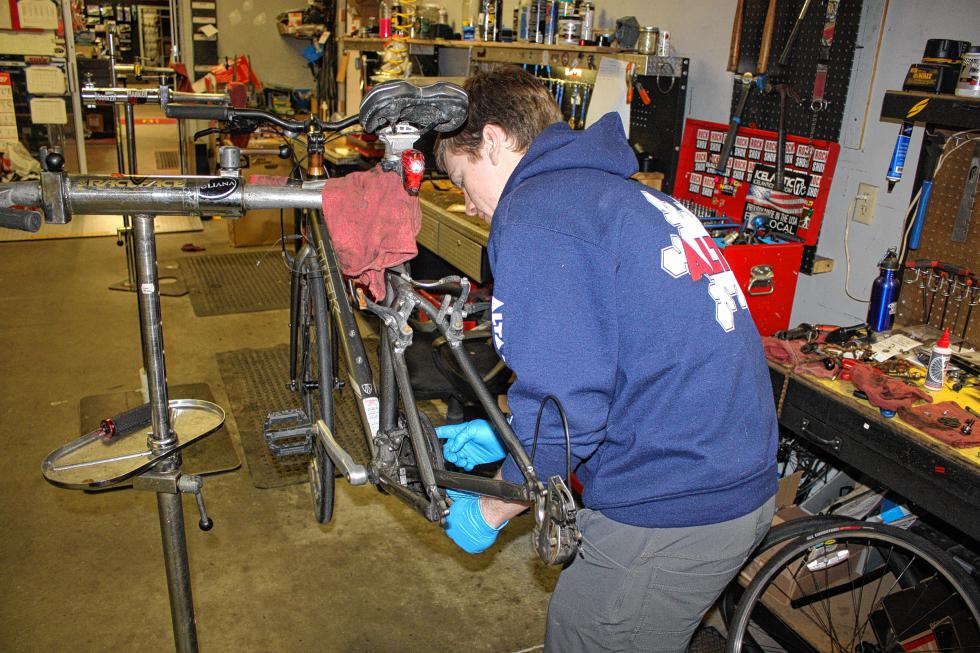 Finn Westbrook works on a bike at S&W Sports in Concord last week. It's getting to be that time of year again. (JON BODELL / Insider staff) -