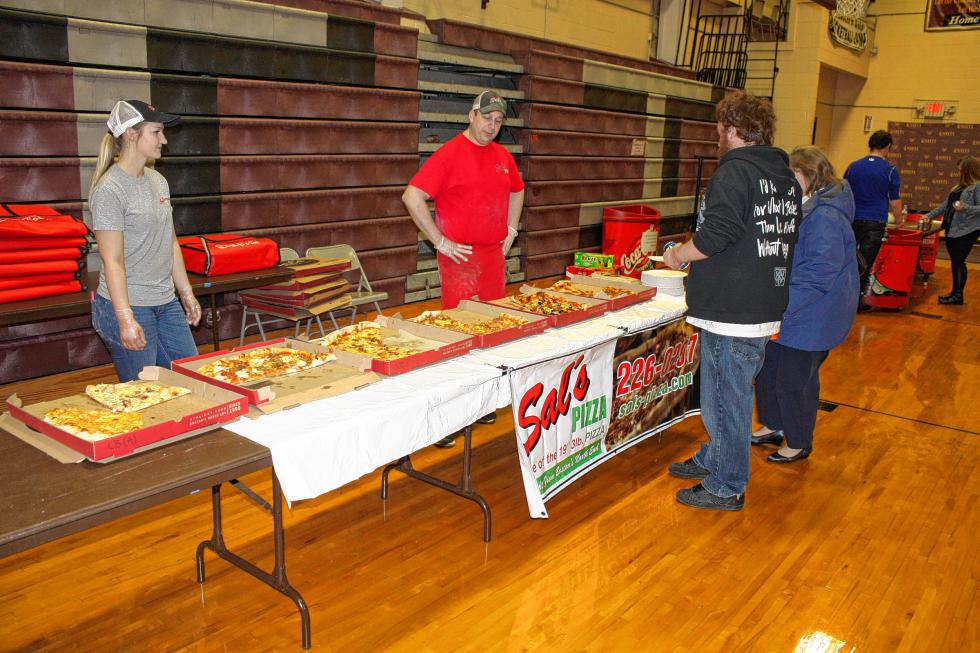 Patrick Blanchette and his mom, Joanne, browse over the options at the Sal's station at NHTI's Pizza Wars. Sal's would go on to win the night, taking the most votes. (JON BODELL / Insider staff) -