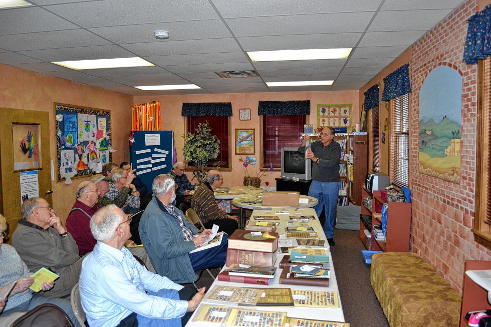 Ron Emery, the de facto auctioneer for the Merrimack County Stamp Collectors, looks for bidders during an auction earlier this month. The club holds auctions every other month, where stamp enthusiasts can buy and sell whatever they choose – if the price is right. (TIM GOODWIN / Insider staff) -