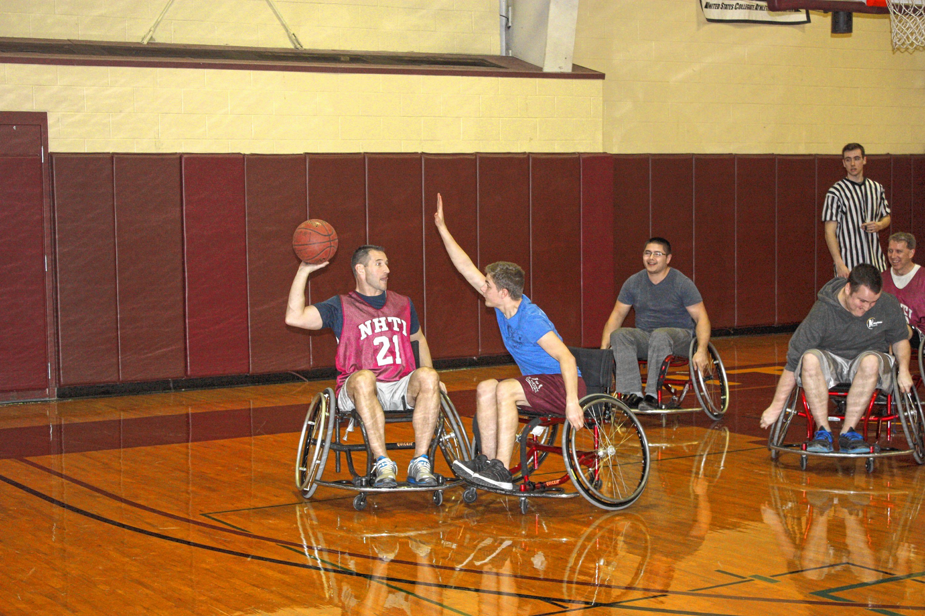 NHTI held its annual Wheelchair Basketball Benefit for the Zech DeVitz Memorial Equipment Fund last week, and a wheelie good time was had by all. Students and faculty members faced off on the court, and about $2,000 was raised to purchase assistive technology for students with disabilities. Nice work, NHTI! Top left: Mike Martineau, on the faculty team, plays some seriously in-your-face defense. Bottom left: NHTI faculty member Chuck Lloyd looks for someone to pass to while a student plays tight defense. Above: Tom Warner of the NHTI admissions department wheels his way toward a loose ball. Look at that determination!