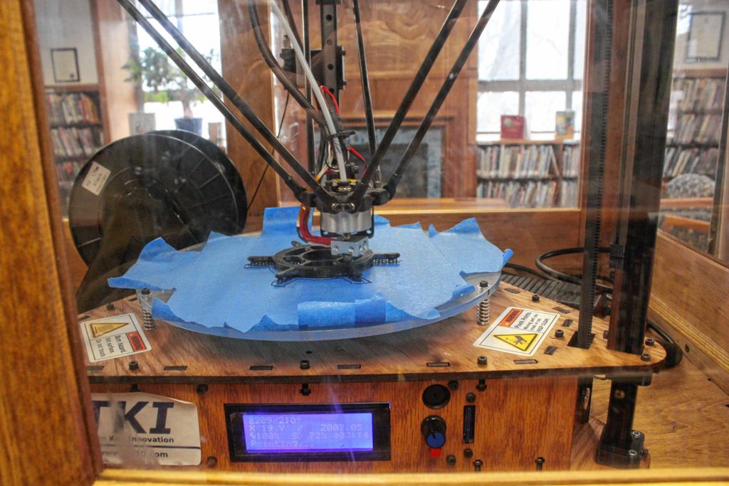 Concord Public Library's 3-D printer, stationed in the children's section upstairs, works on making a ship's steering wheel last week.(JON BODELL / Insider staff)