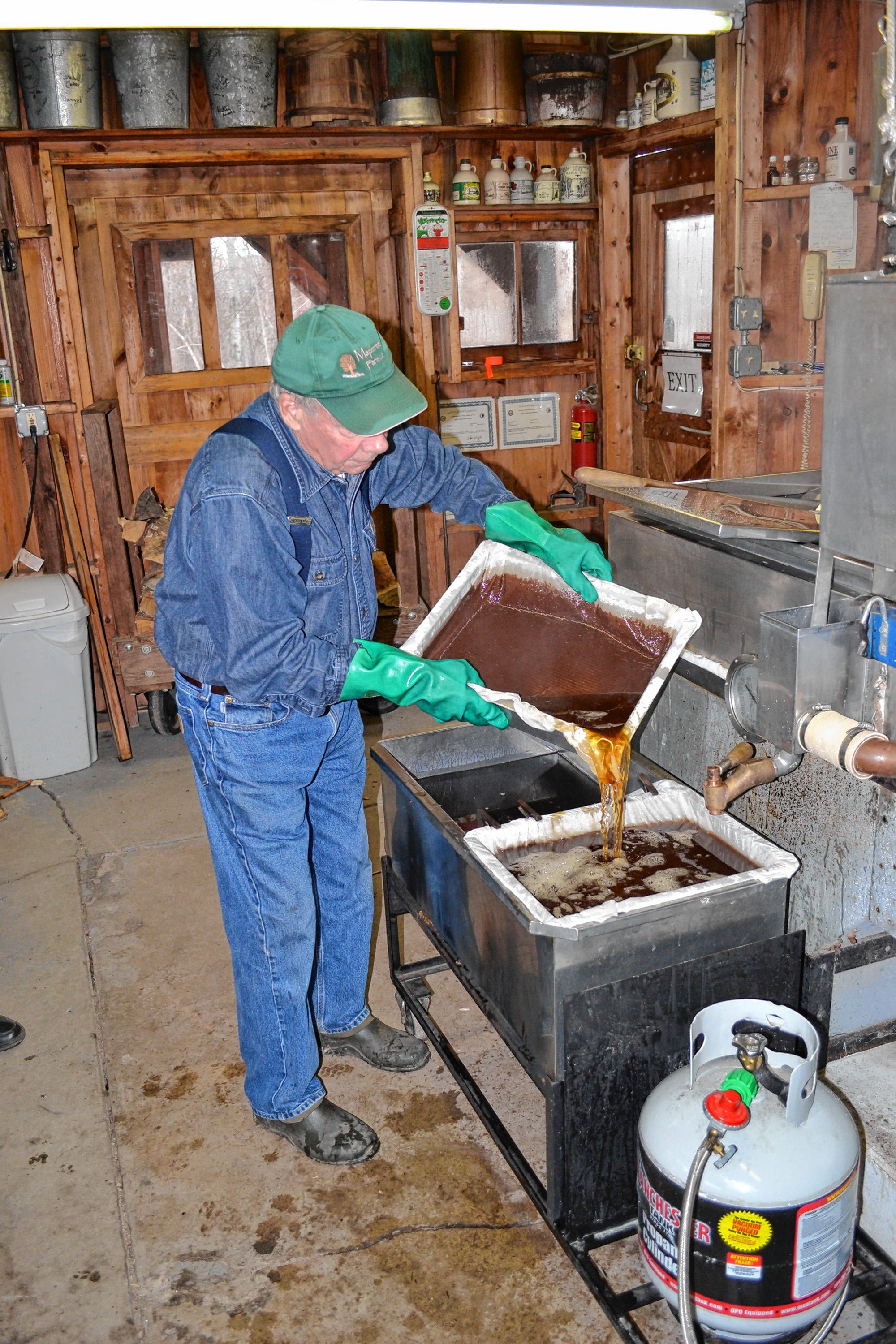 Since Mother Nature didn’t exactly cooperate with all of our ideas for the Maple Issue, we weren’t able to show you the actual process of turning sap into maple syrup. So when Mapletree Farm owner Dean Wilber informed us he had gathered about 1,000 gallons of sap to boil one day last week, you bet we were going to stop by and check it out. After putting all that sap through his reverse osmosis machine, Wilber had 300 gallons of concentrated sap, which turned into a little more than 20 gallons. Top left: Wilber pours fresh syrup through the pre-filter. Top right: It’s always a good sign when you see steam billowing from a sugar house. Above: You need that fire rip-roaring to get the sap boiling.