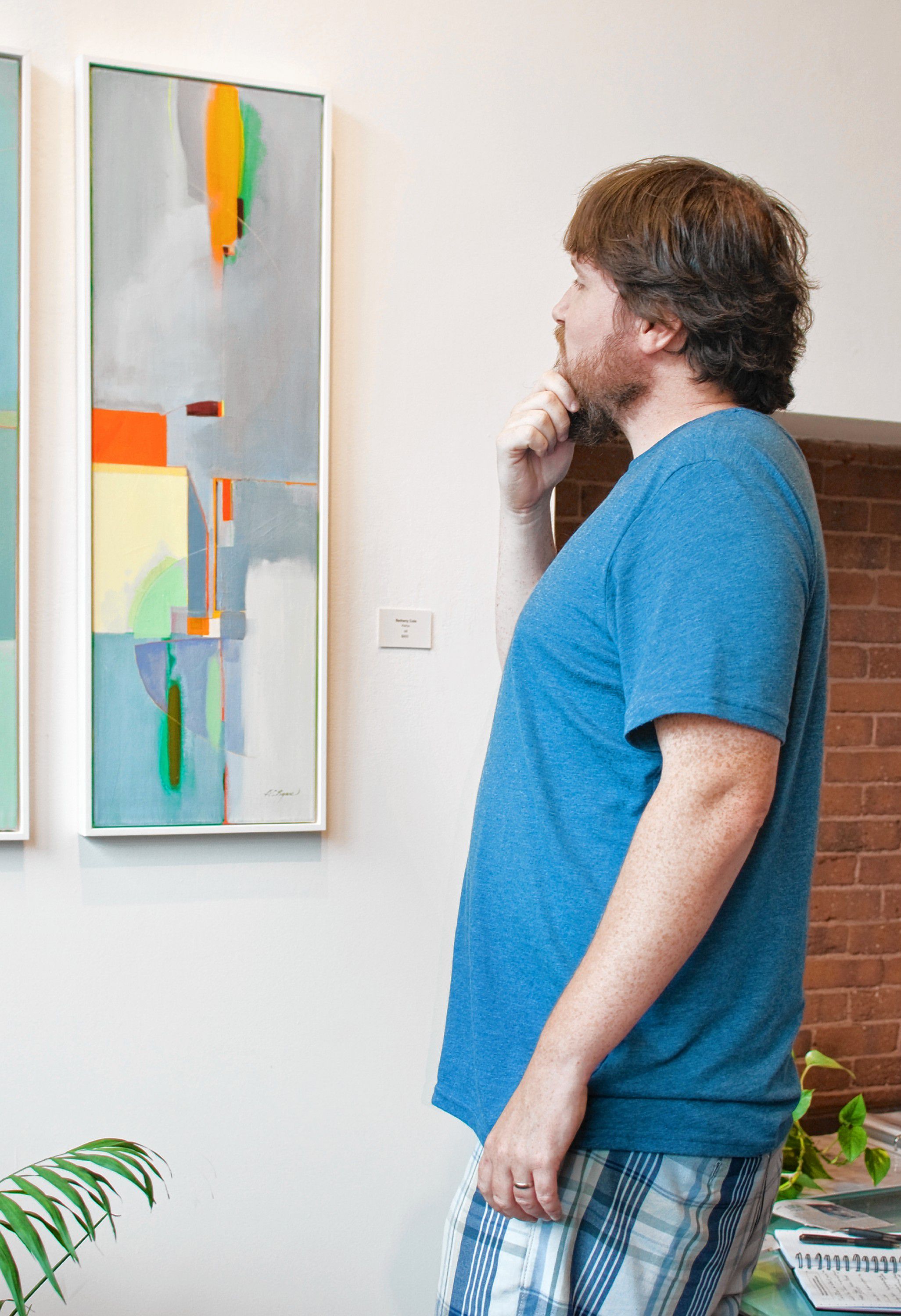 Tim contemplates a painting by Bethany Cole Rymes, "Kairos," during the McGowan Fine Art opening for 'Inertia.' Luckily the photos didn't catch him stuffing his face with cheese, crackers and grapes. JULIE HAMEL / For the Insider