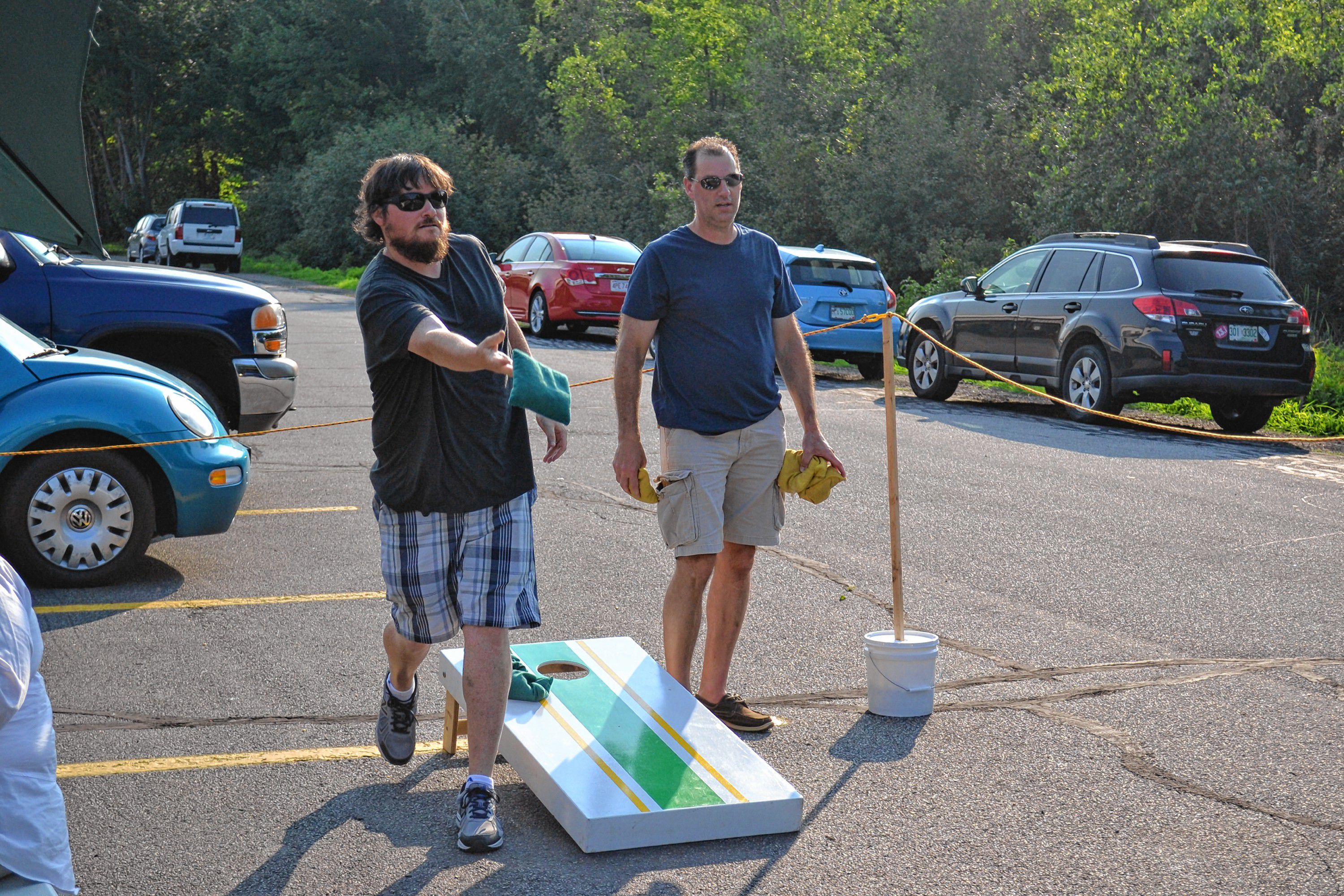 Tim plays a round of cornhole at Lithermans Limited with patron Brian Peters on July 21. The Hall Street brewery now serves full pints and offers an outdoor seating area featuring the popular bean bag-toss game. JON BODELL / Insider staff