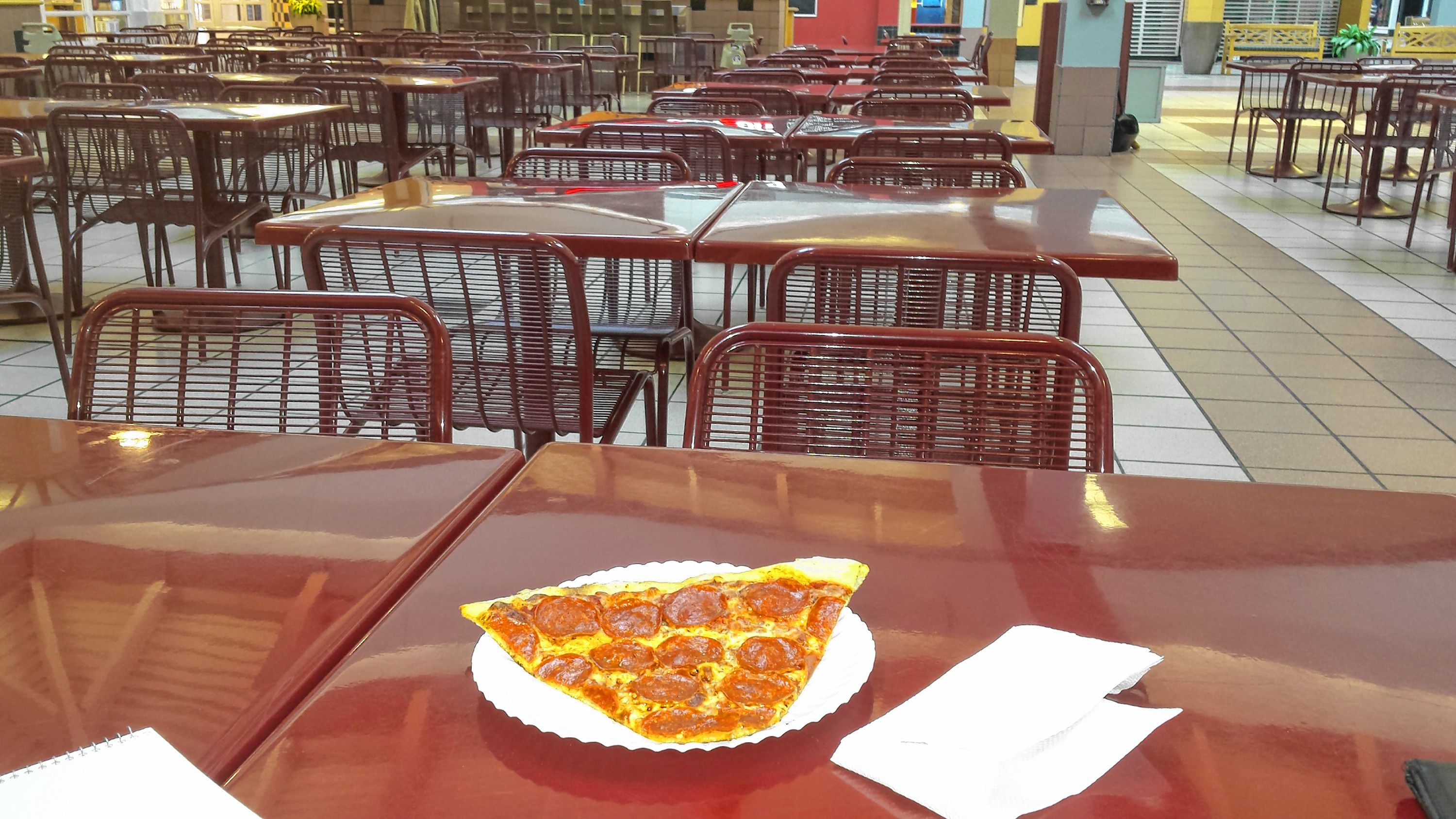 Tim grabbed a slice of pizza from Basil Pizza & More at the Steeplegate Mall last week. There were plenty of seats available in the food court. TIM GOODWIN / Insider staff