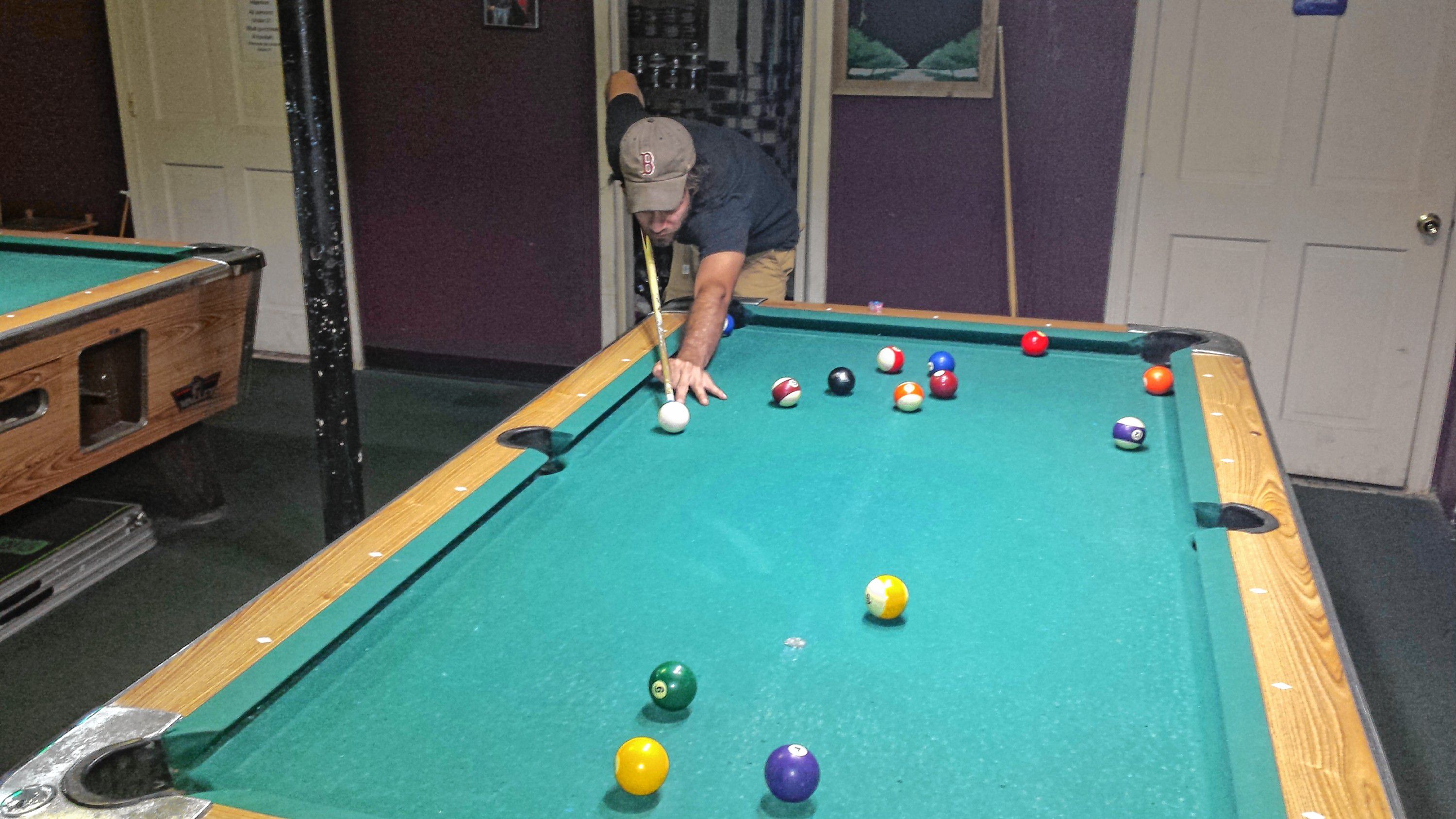 Jon lines up a shot on the pool table at Chi Cha Hookah Bar and Smoking Lounge on July 21. He handled Tim with ease in this round of 8-ball. TIM GOODWIN / Insider staff