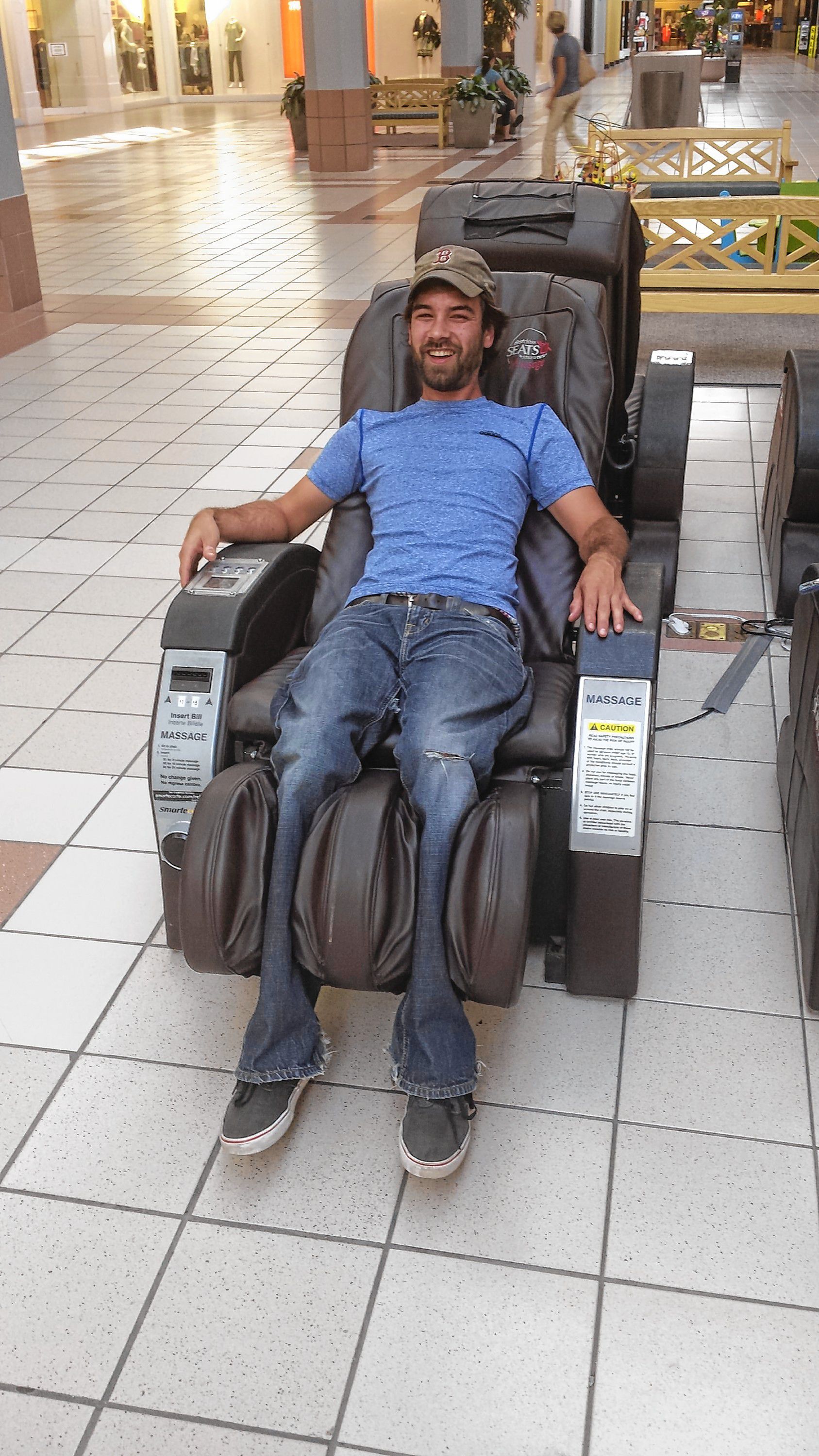 Jon gets an awkward and at times uncomfortable massage from a chair at Steeplegate Mall last week. For just one dollar, you can get a full 3-minute massage, with lots of control over the massage intensity and patterns. TIM GOODWIN / Insider staff