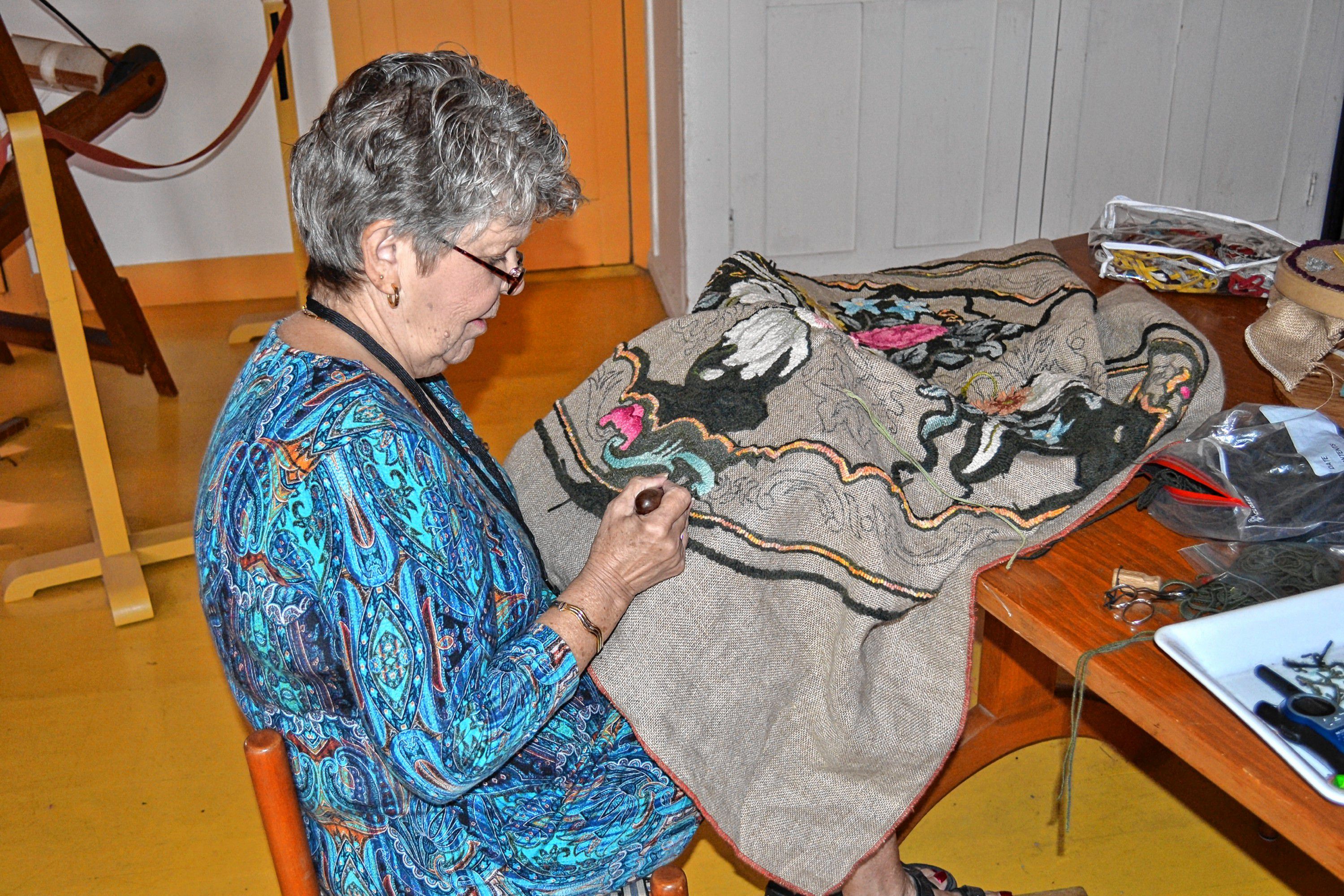 Carol Lachance puts on a rug hooking demo at Canterbury Shaker Village. Tim Goodwin / Insider staff