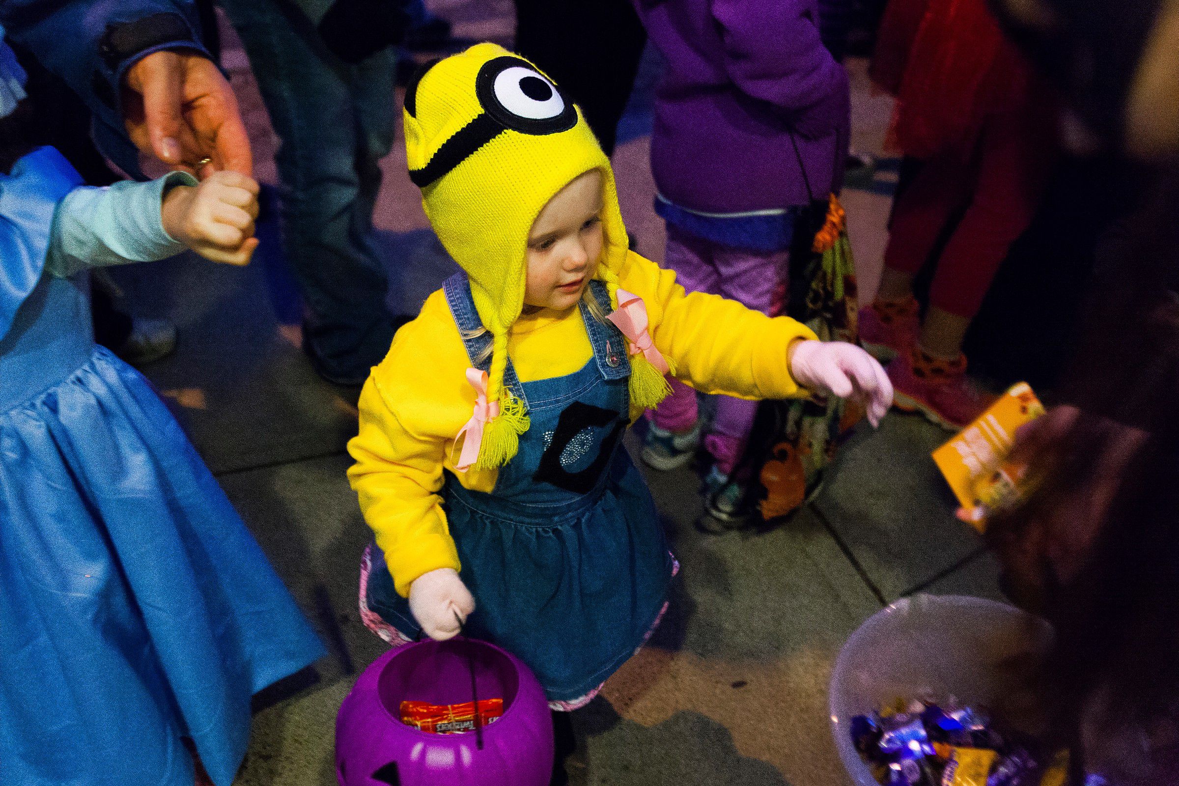 Two-year-old Lyric Doane of Concord trick-or-treats dressed as a minion from "Despicable Me" during the annual Downtown Halloween Howl on Main Street in Concord on Friday, Oct. 24, 2014.  (ELIZABETH FRANTZ / Monitor staff) ELIZABETH FRANTZ