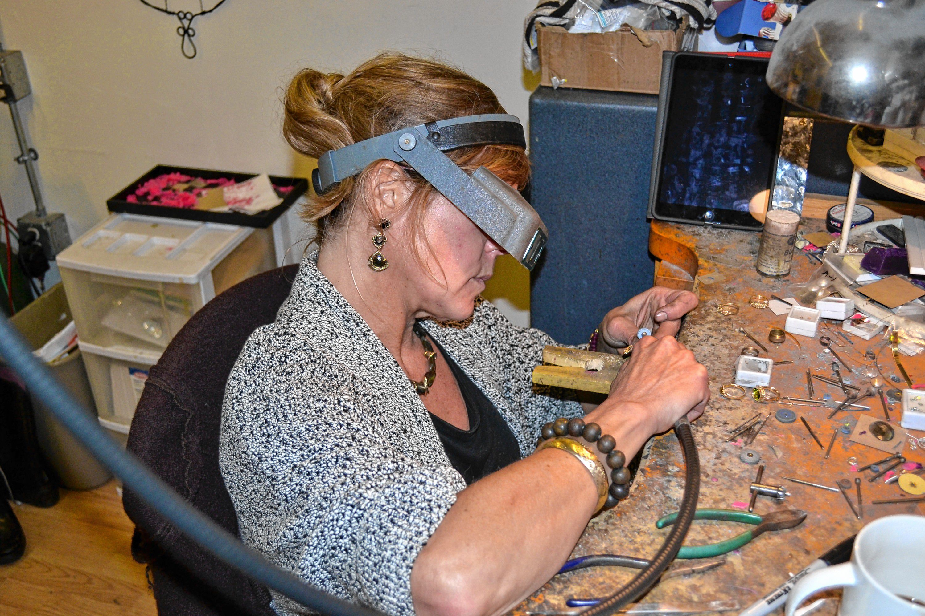 Kristin Kennedy works on a piece of jewelry in her downtown Concord studio. TIM GOODWIN / Insider staff