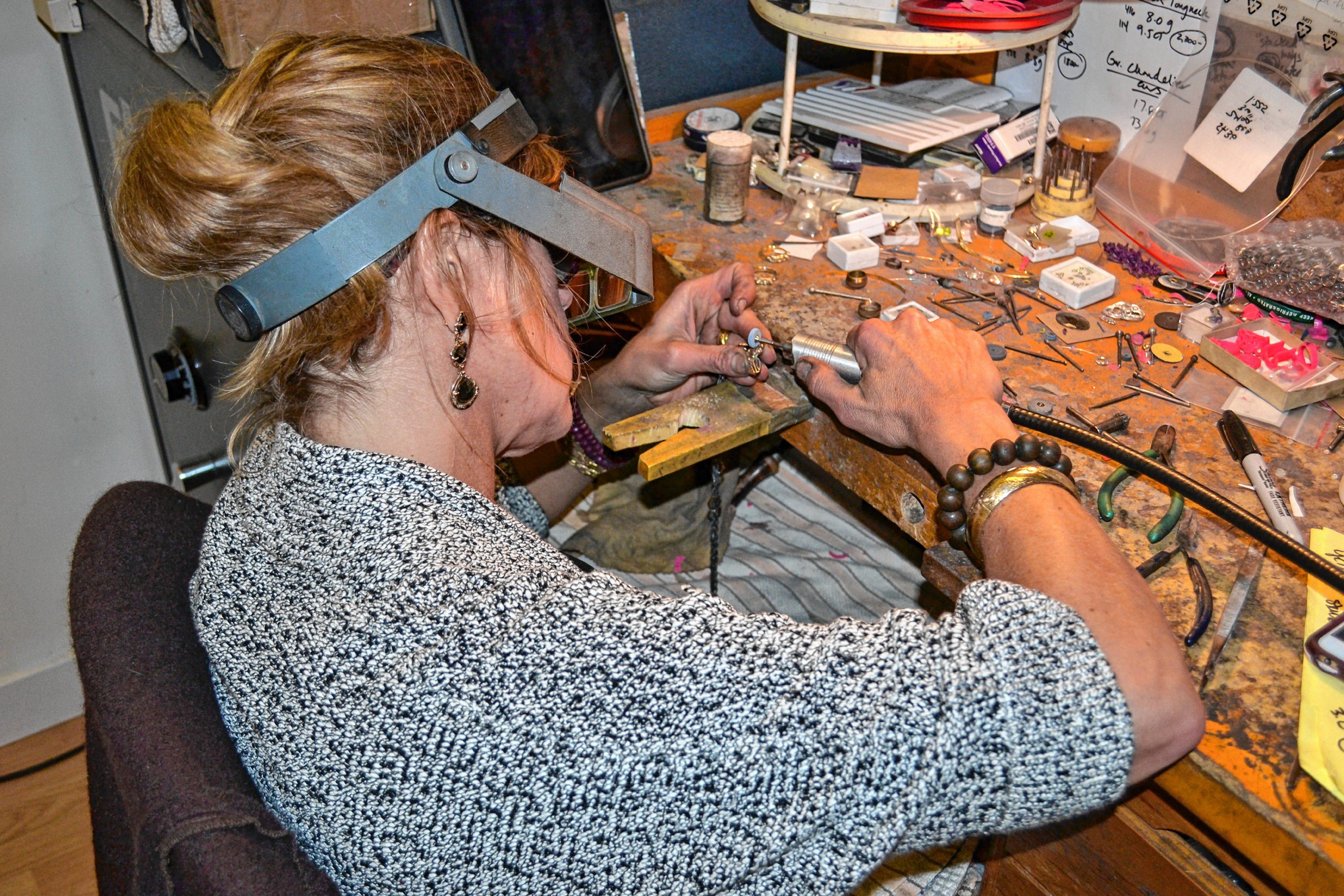 Kristin Kennedy works on a piece of jewelry in her downtown Concord studio. TIM GOODWIN / Insider staff