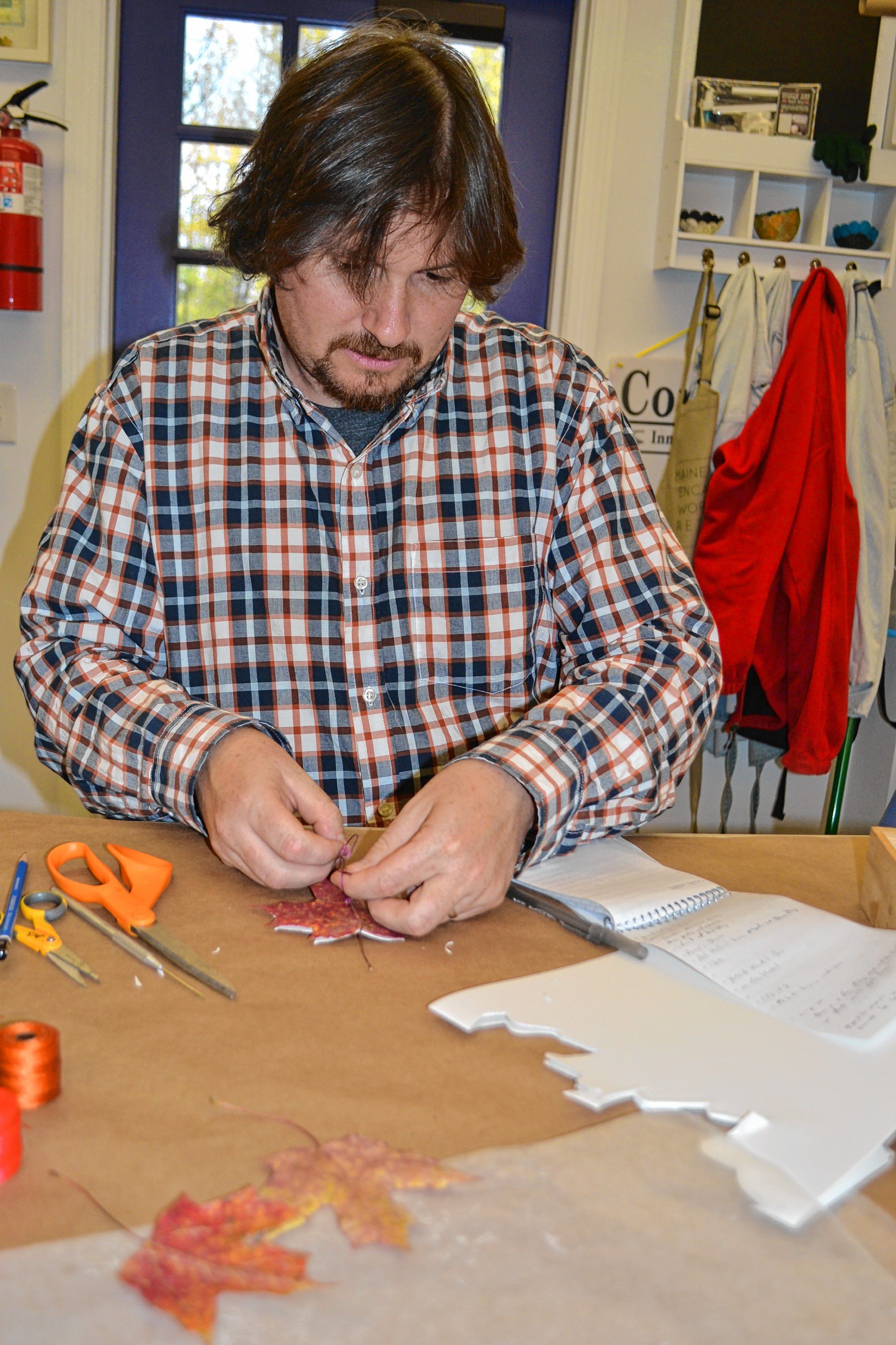 Tim makes a leaf book at Twiggs Gallery, a craft that you can try during a visit to the Boscawen art hotspot. ADELE SANBORN / For the Insider