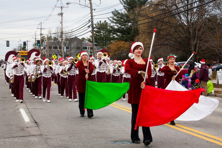 The Concord High School marching band and color guard walk in the