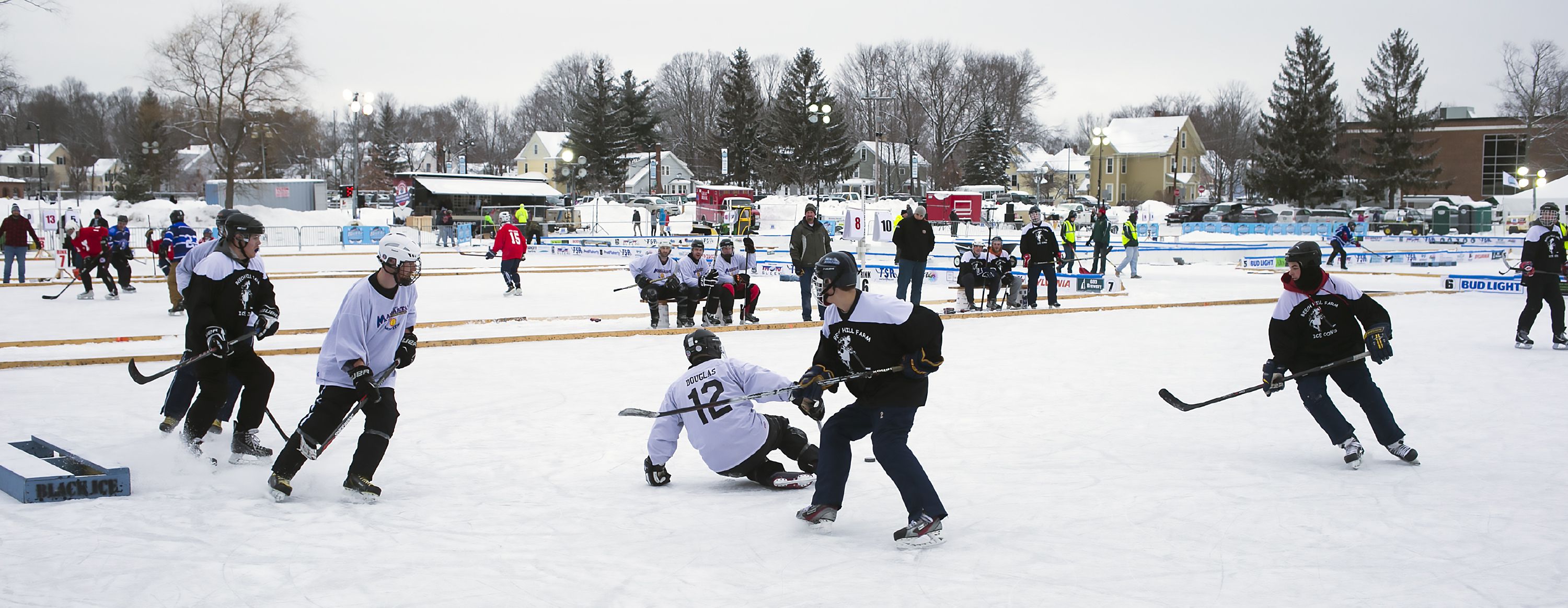 Teams compete at the Black Ice Pond Hockey Tournament at White Park in Concord Saturday. GEOFF FORESTER