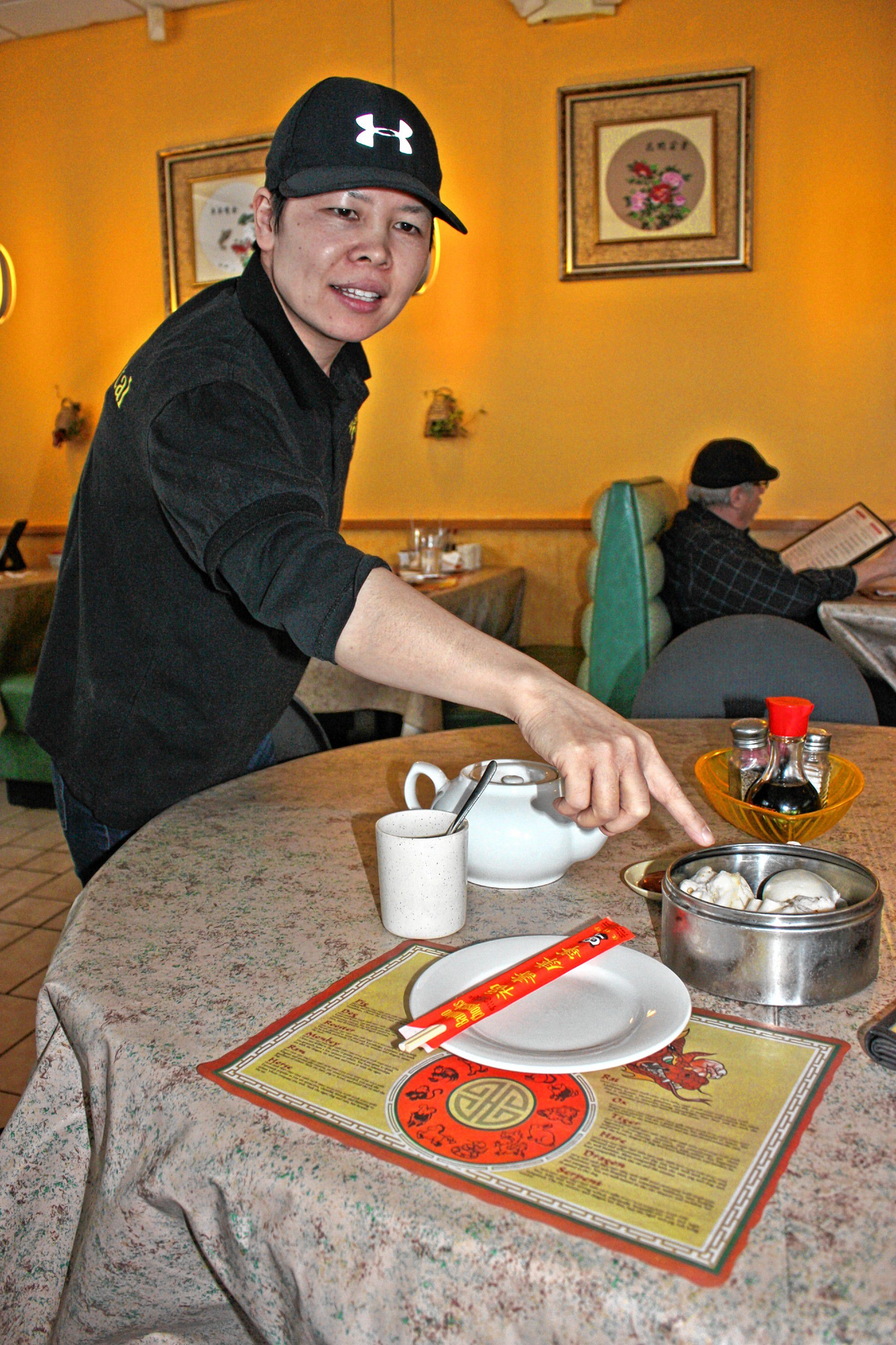 Tina Tan, whose family owns Sunshine Oriental on Loudon Road, brings Jon a tray of three steamed buns: barbecue pork, chicken and Nai Wong. Sunshine Oriental offers authentic, traditional Chinese food (as well as plenty of the Americanized stuff you're probably more familiar with). JON BODELL / Insider staff