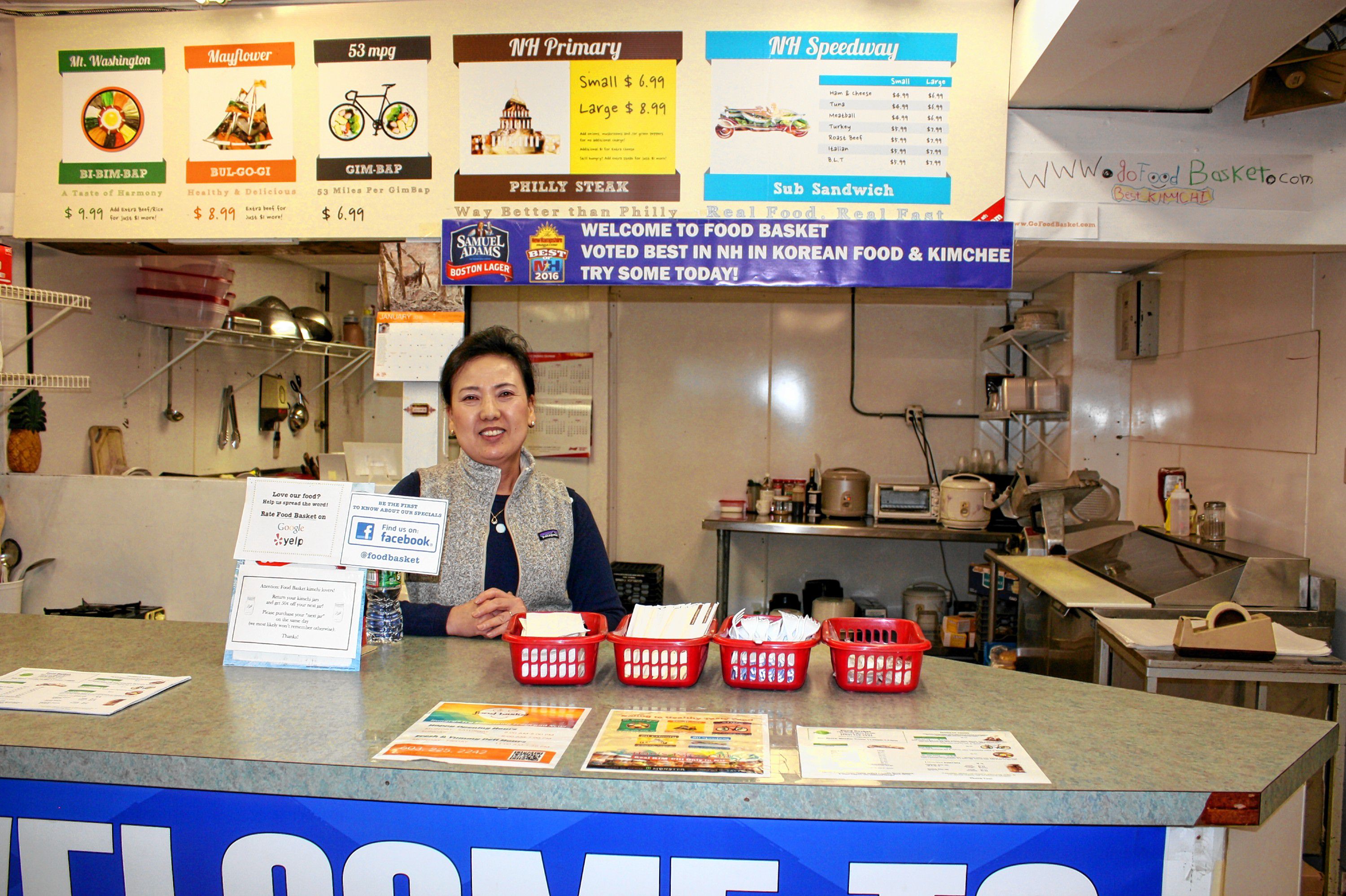 Helen Han stands behind the food counter at Go Food Basket on Washington Street last week. The Asian grocery store also serves up authentic Korean food, including its famous kimchi made fresh by Han right there in the store. JON BODELL / Insider staff