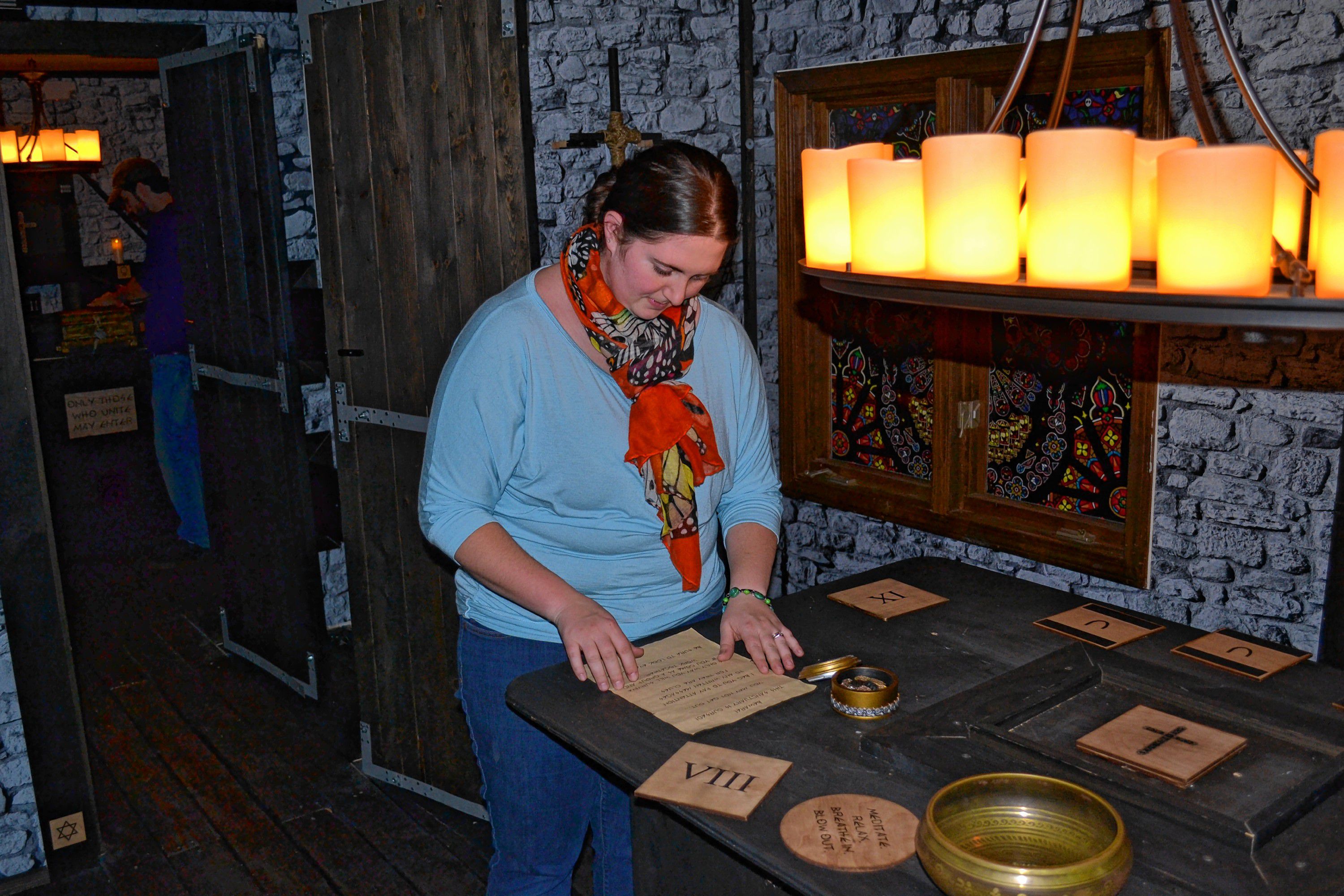 Monitor staffer Sarah Pearson is hard at work trying to crack the case of The Sanctuary at Escape Room Concord. TIM GOODWIN / Insider staff