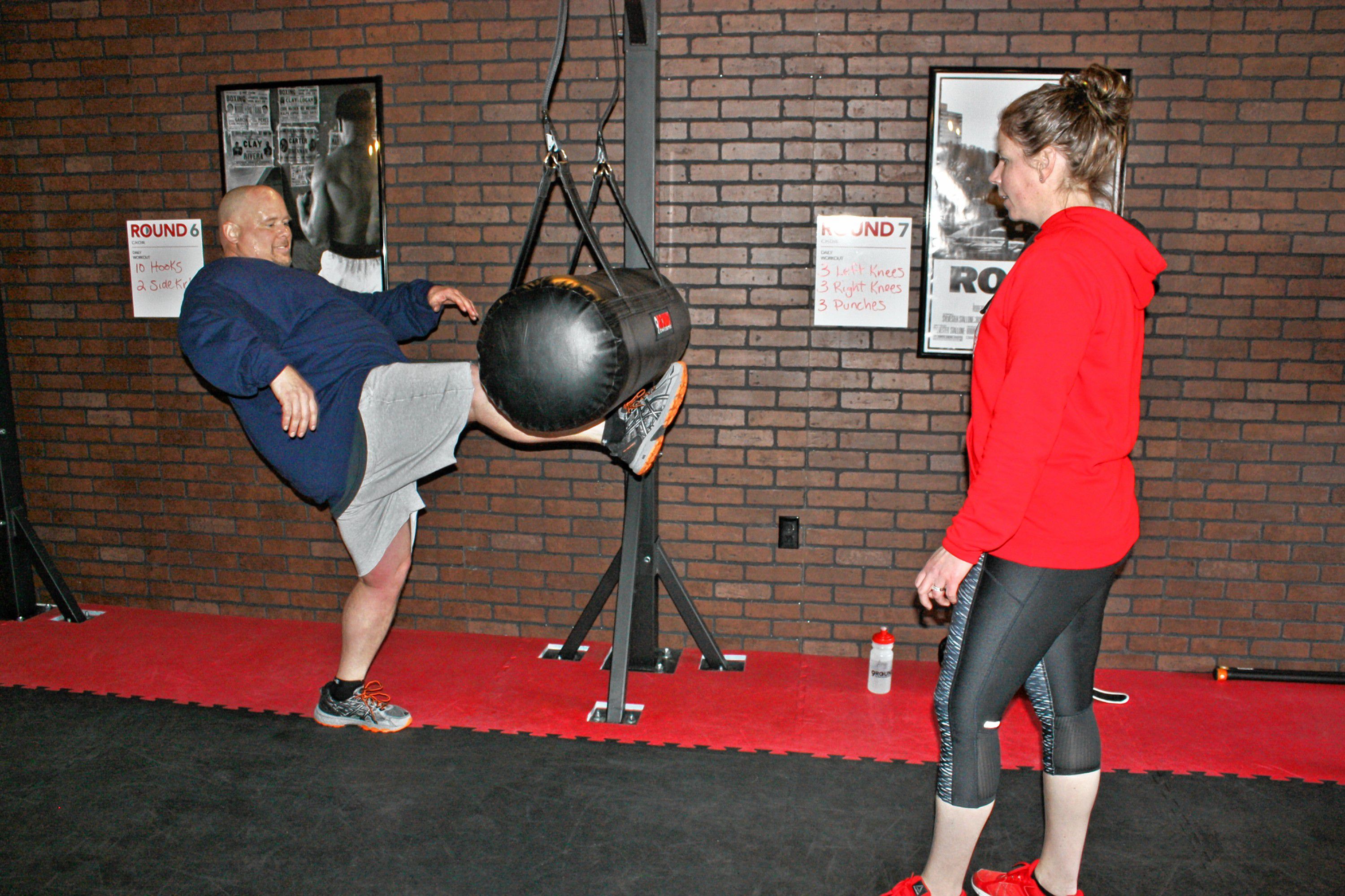 9Round owner Laurie Weingartner works with Les Reed on a kicking workout at 9Round, the new kickboxing-style gym on Ford Eddy Road, last week. JON BODELL / Insider staff