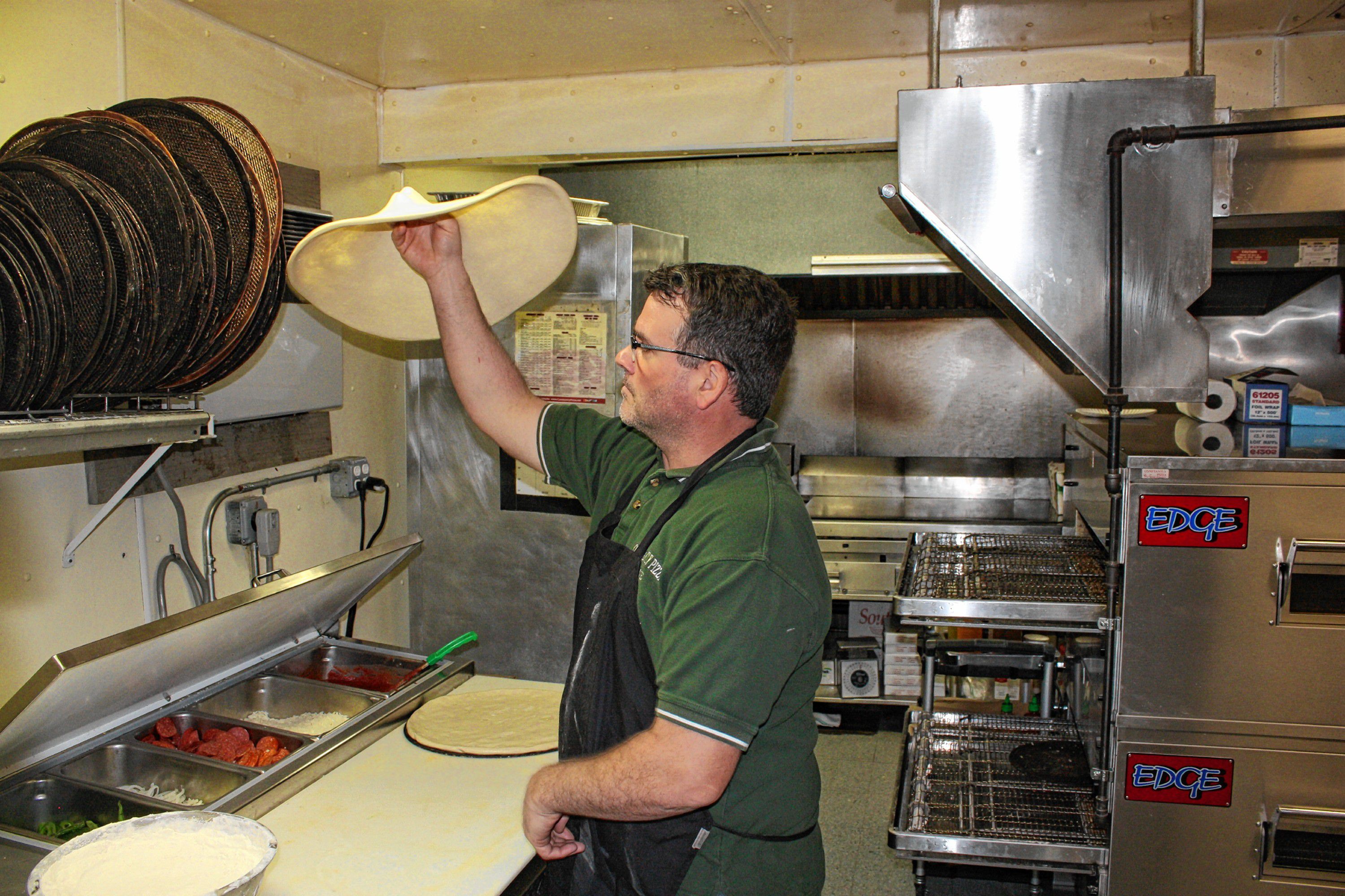 Constantly Pizza co-owner Dave Constant whips up a pepperoni pizza at the downtown location last week. Constant has been making pizza for so long now he can spin a dough on his finger like a Harlem Globetrotter does with a basketball. JON BODELL / Insider staff