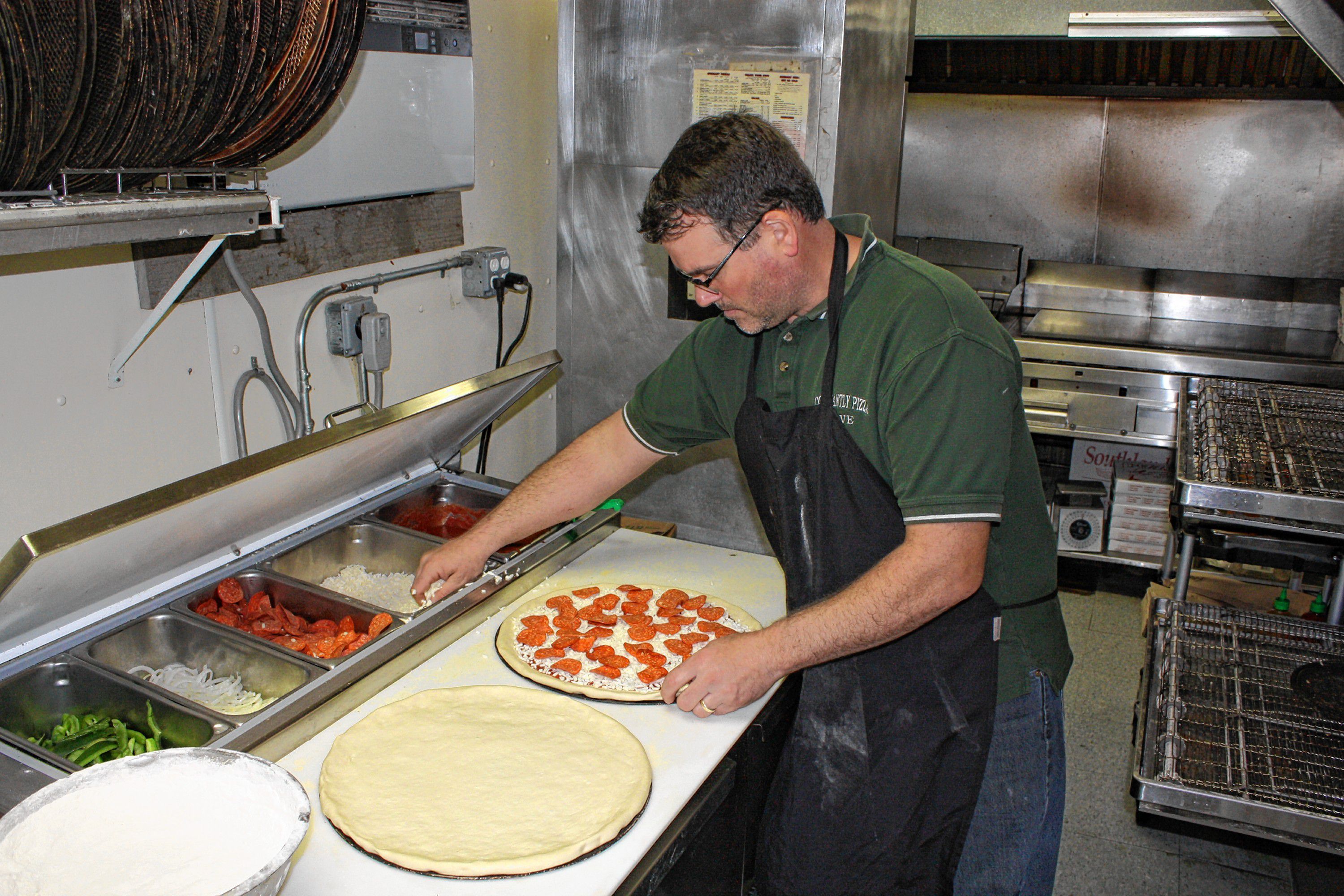 Constantly Pizza co-owner Dave Constant whips up a pepperoni pizza at the downtown location last week. Constant has been making pizza for so long now he can spin a dough on his finger like a Harlem Globetrotter does with a basketball. JON BODELL / Insider staff