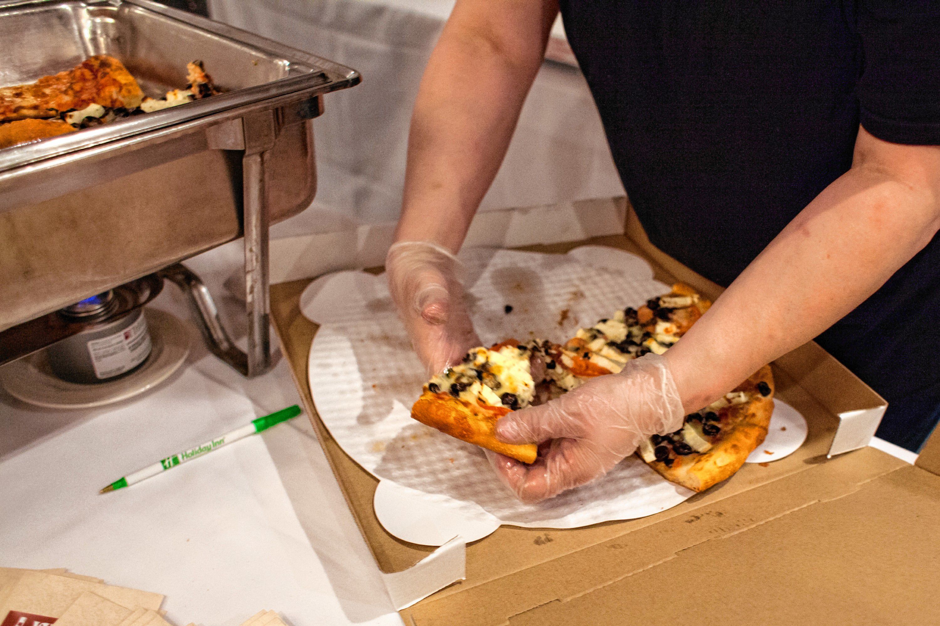 Veano's Italian Kitchen serves slices of Greek pizza during the Pizza Pie Showdown at the Holiday Inn in downtown Concord on Pi Day, Mar. 14, 2018. Proceeds from the event, hosted by the Concord Monitor and Insider, went to support the Friendly Kitchen. (ELIZABETH FRANTZ / Monitor staff) Elizabeth Frantz