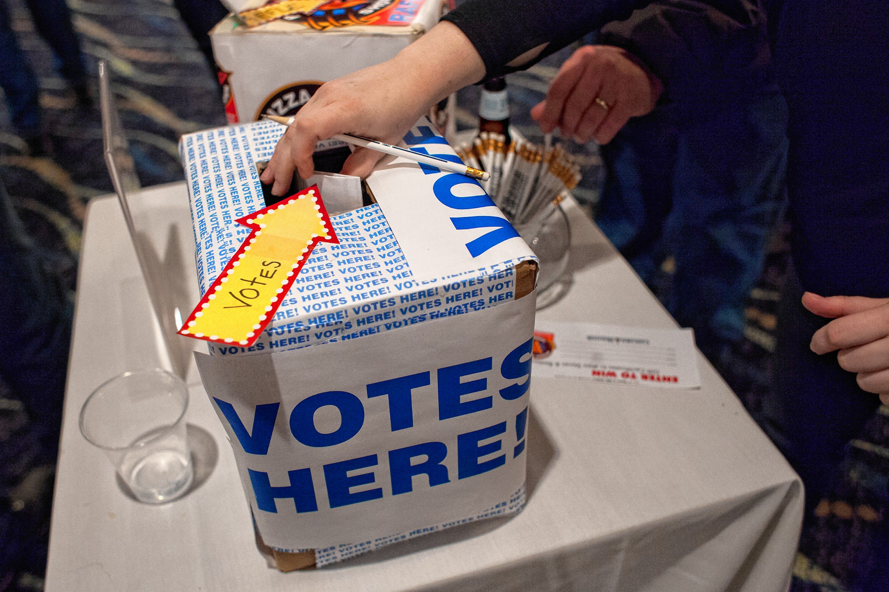 People place ballots into the voting box during the Pizza Pie Showdown at the Holiday Inn in downtown Concord on Pi Day, Mar. 14, 2018. Proceeds from the event, hosted by the Concord Monitor and Insider, went to support the Friendly Kitchen. (ELIZABETH FRANTZ / Monitor staff) Elizabeth Frantz