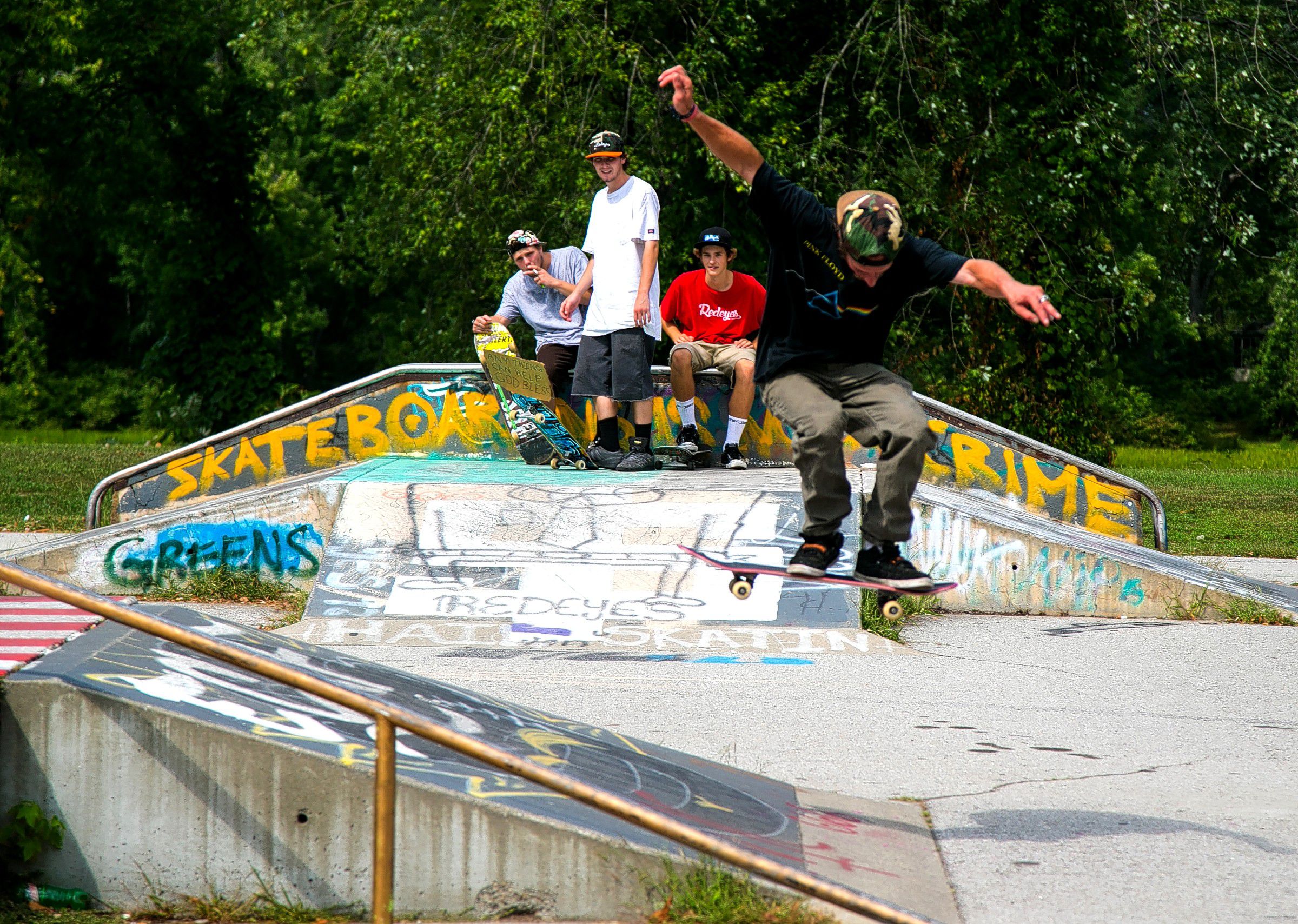 Tyler Castrogiovanni (left), Chris Rydel (middle) and Freddie Seekamp all watch as Nick Gambino attempts difficult jump at the Concord skateboarding park on Loudon Road earlier this week. Gambino was back from Colorado visiting friends.  (GEOFF FORESTER / Monitor staff) GEOFF FORESTER