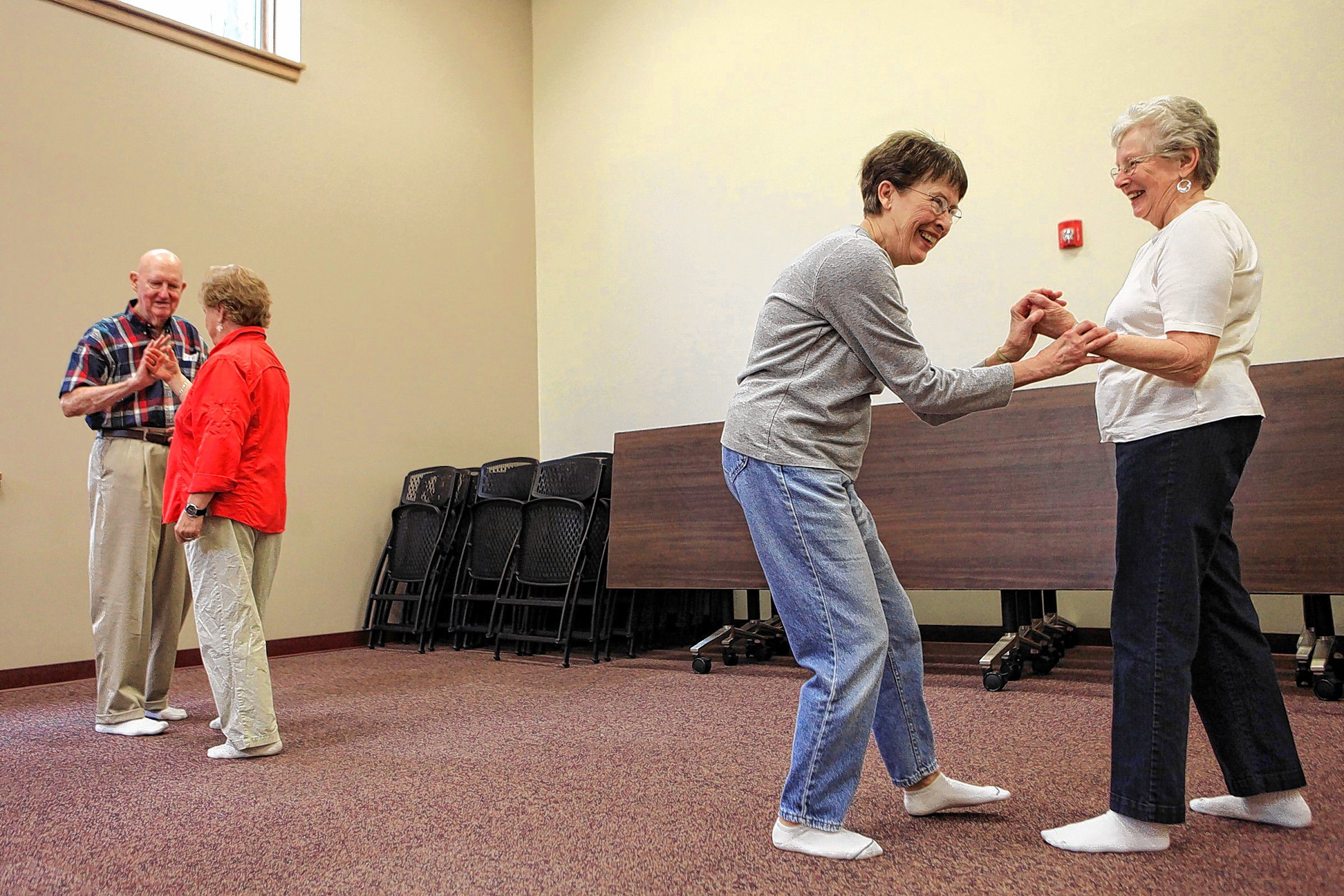 Pat Miniutt (right) and her sister-in-law Nancy Miniutti laugh as they try reposition themselves while they were working on a push hands training routine during a tai chi class on April 15, 2014. The Centennial Center was being renamed Good Life Programs and has expanded its membership from about 60 to almost 1,000 in a year. (ARIANA van den AKKER / Monitor staff) 