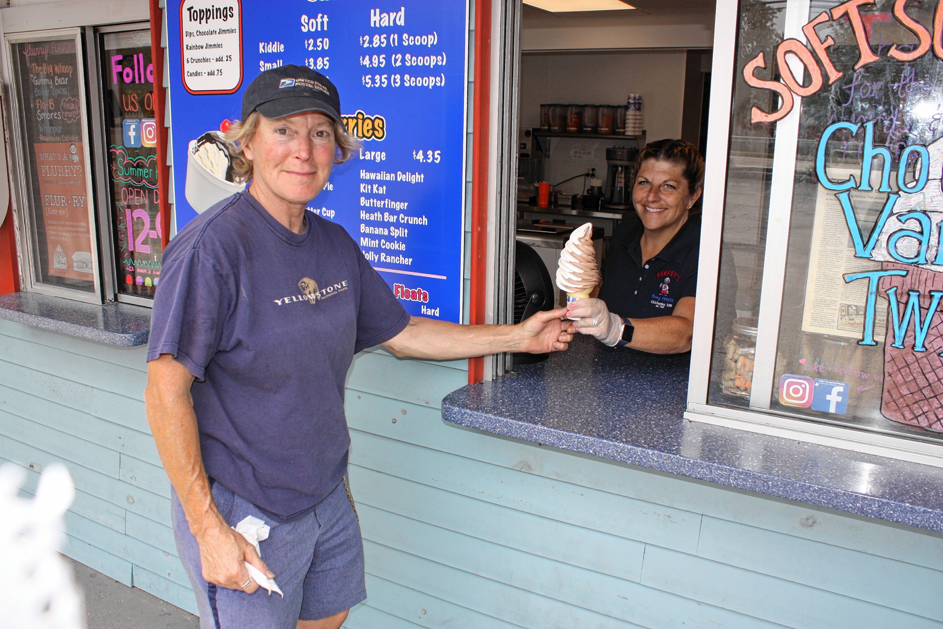 Carol Frekey-Harkness, owner of Frekey's Dairy Freeze, serves a soft-serve cone to Chris Buckley on an overcast Wednesday last week.  JON BODELL / Insider staff