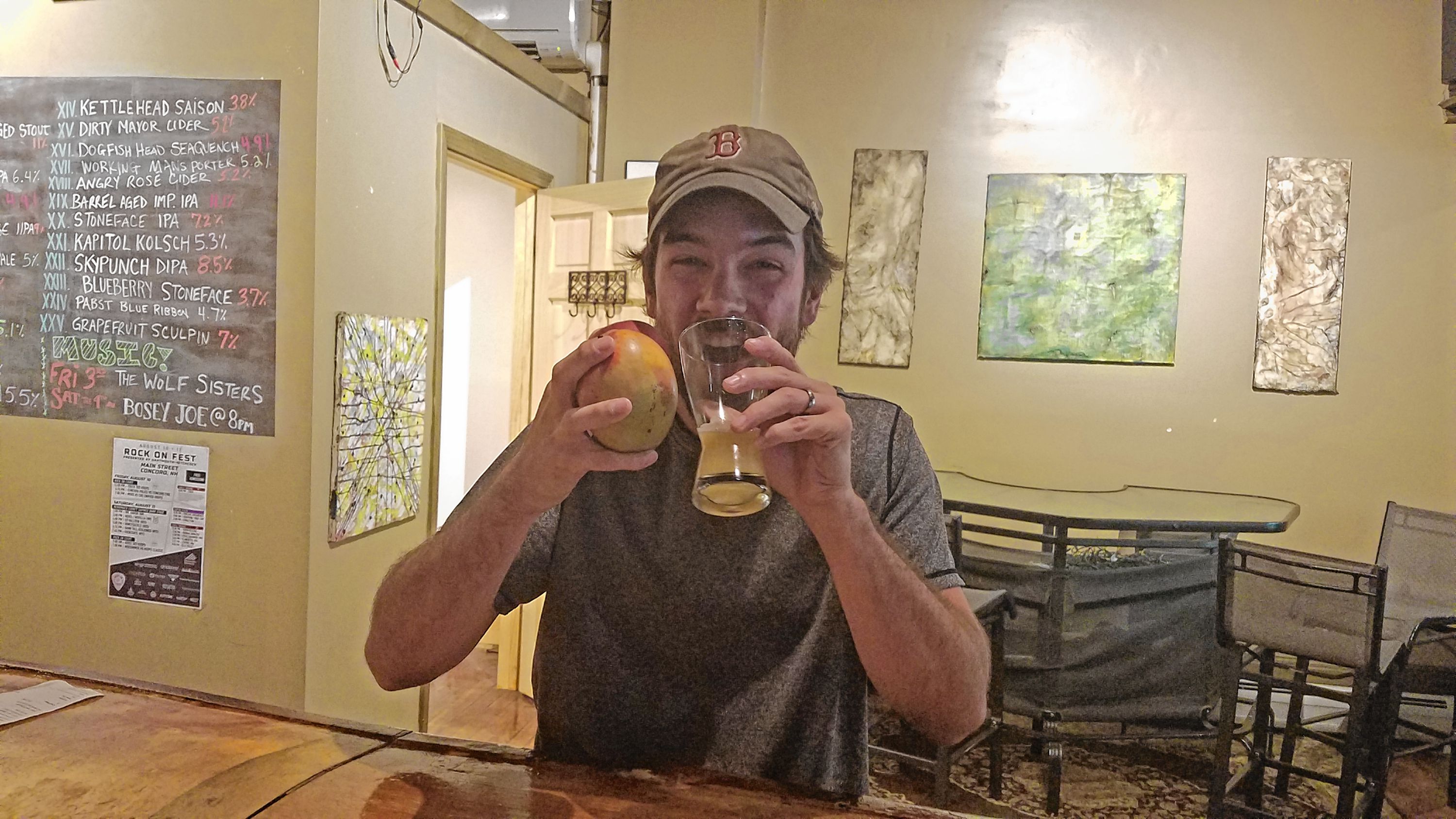 Jon attempts to drink Concord Craft Brewing Co.'s Safe Space New England IPA while also eating a mango and a peach at True Brew Barista last week. He failed miserably, but it was a fun time trying. JILL FELLBAUM / For the Insider