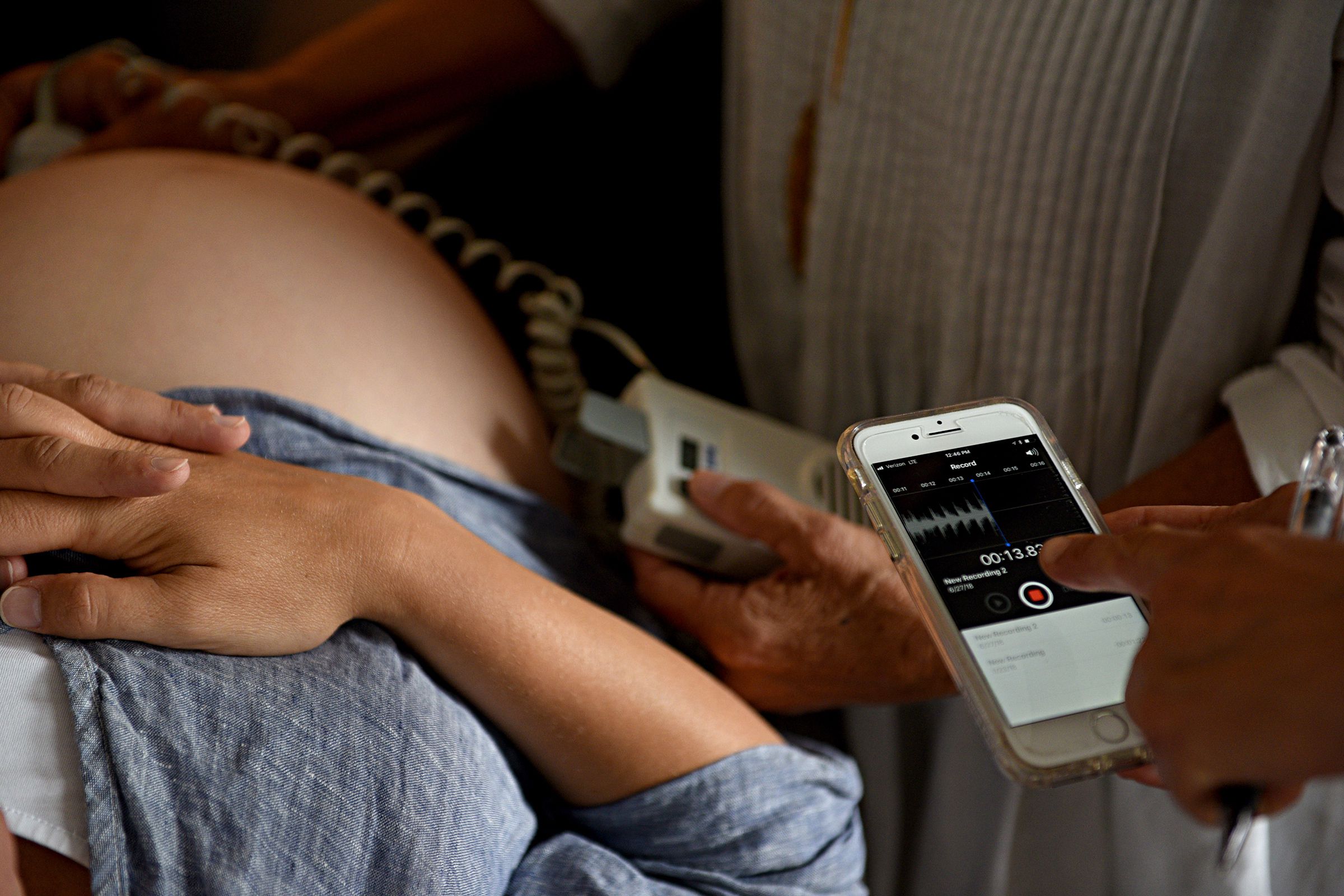 Midwife Katherine Bramhall listens to Maeghan Finnigan's baby's heartbeat during an office visit in Lebanon, N.H. on June 27, 2018. Finnigan plans to deliver her baby at home with Bramhall attending her. Lauren Godfrey, Bramhall's summer intern records the heart beat for Finnigan. (Valley News - Jennifer Hauck) Copyright Valley News. May not be reprinted or used online without permission. Send requests to permission@vnews.com. Jennifer Hauck